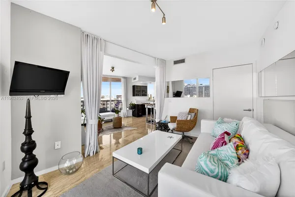 a living room with furniture and a flat screen tv