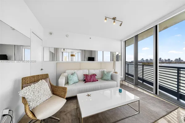 a living room with furniture and a large window