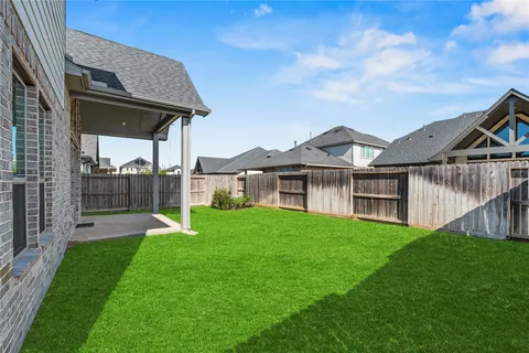 a view of a house with a yard and sitting area
