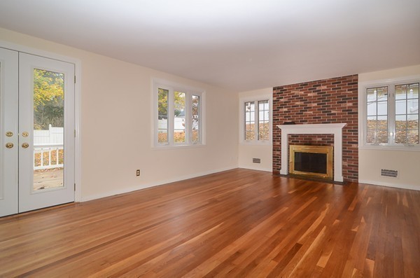 560 Worcester Street Wellesley, MA 02481 - Photo 4 of 10 wooden floor fireplace and windows in an empty room