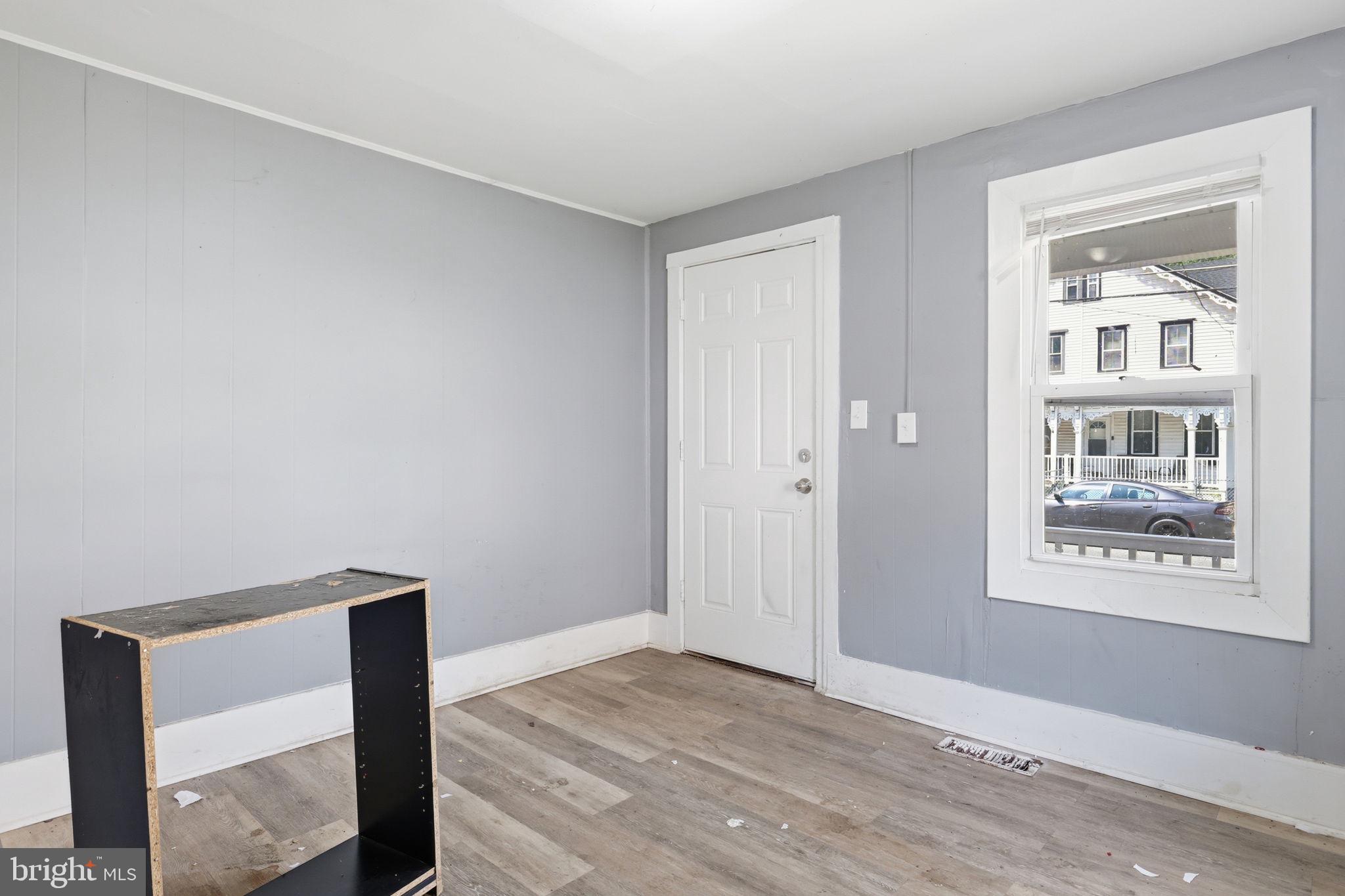60 Walnut Street Salem, NJ 08079 - Photo 7 of 25 a view of an empty room with wooden floor and a window