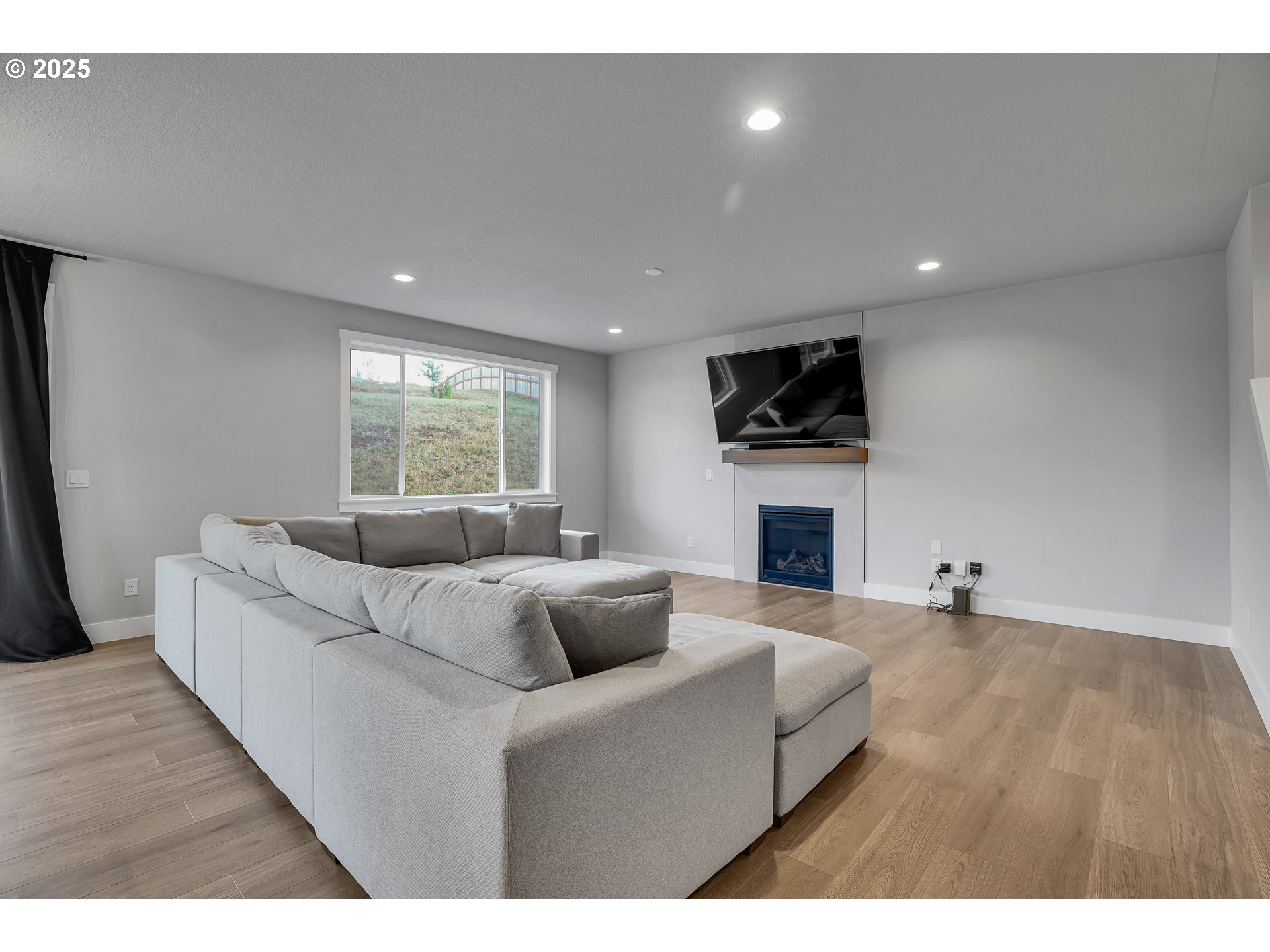 38249 Mulberry Street Sandy, OR 97055 - Photo 13 of 44 a living room with furniture a fireplace and a flat screen tv