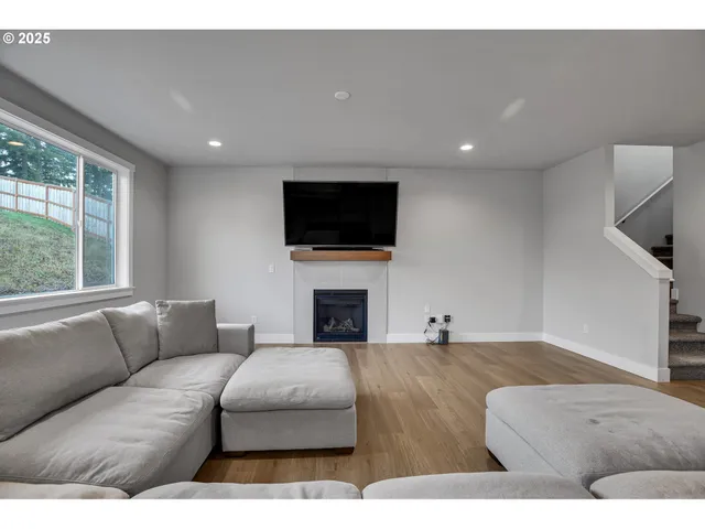 a living room with furniture a fireplace and a flat screen tv