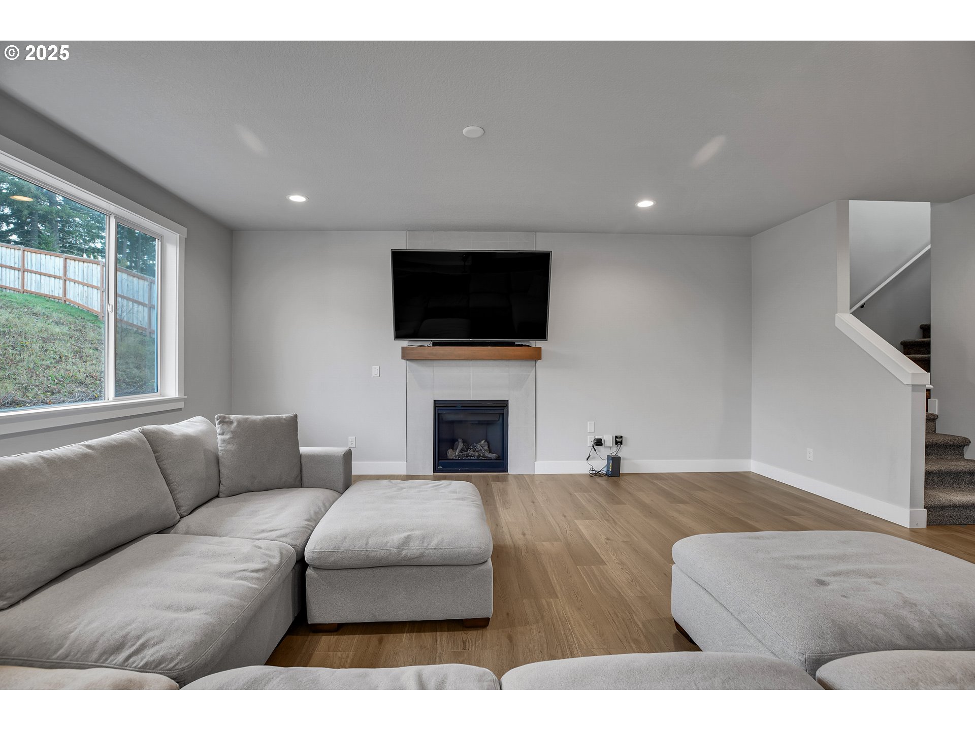 38249 Mulberry Street Sandy, OR 97055 - Photo 14 of 44 a living room with furniture a fireplace and a flat screen tv