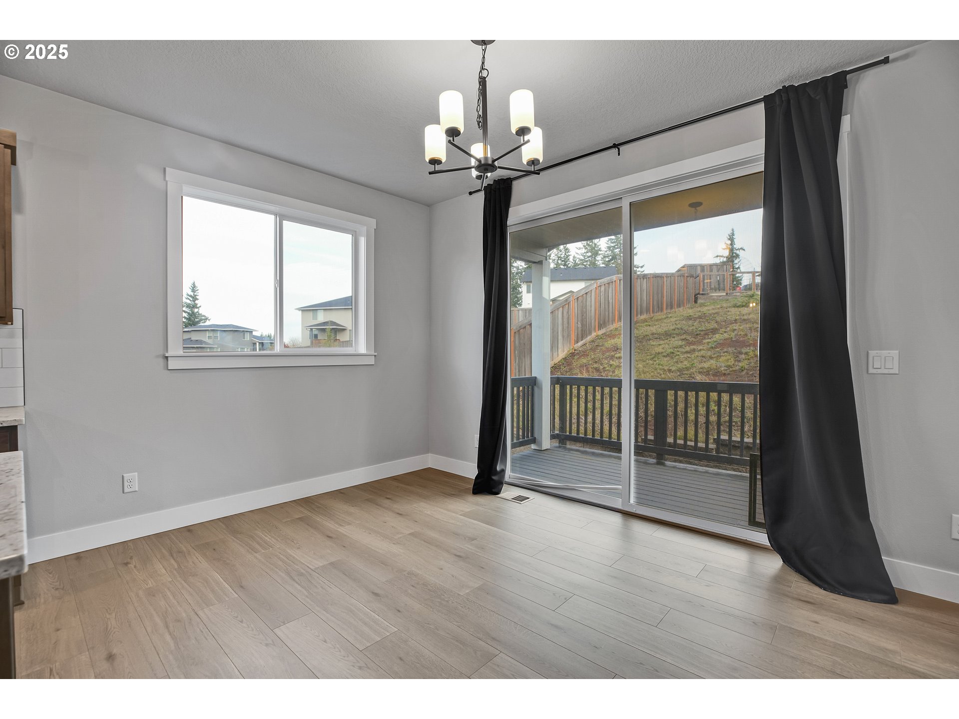 38249 Mulberry Street Sandy, OR 97055 - Photo 15 of 44 a view of an empty room with wooden floor and a window