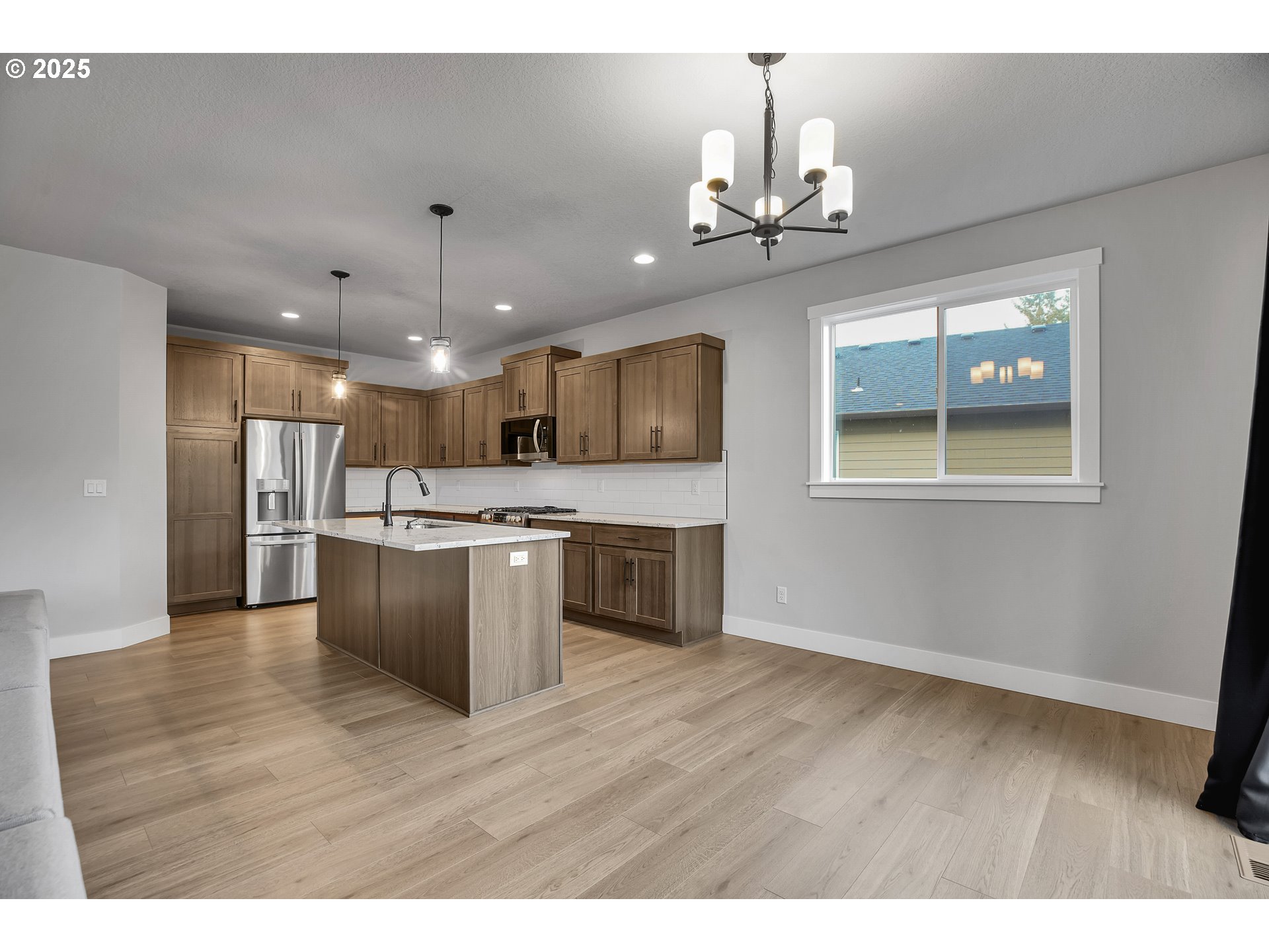 38249 Mulberry Street Sandy, OR 97055 - Photo 16 of 44 a view of kitchen with granite countertop cabinets stainless steel appliances and a chandelier