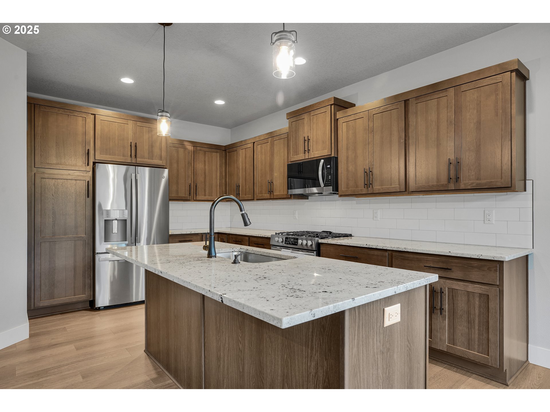 38249 Mulberry Street Sandy, OR 97055 - Photo 20 of 44 a kitchen with stainless steel appliances granite countertop a sink stove and refrigerator