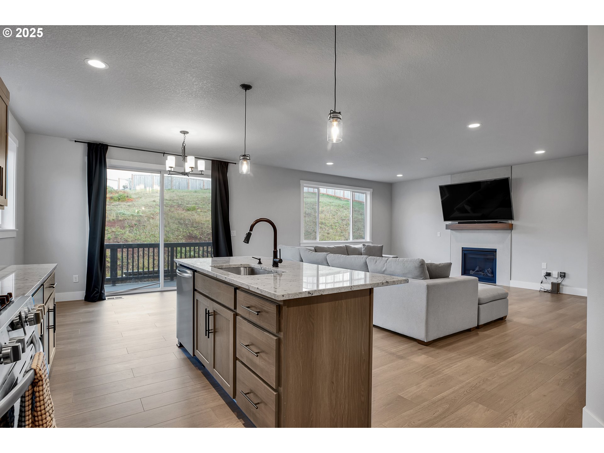38249 Mulberry Street Sandy, OR 97055 - Photo 22 of 44 a living room with furniture a flat screen tv and a large window