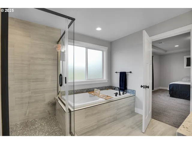 a bathroom with a sink mirror and a shower