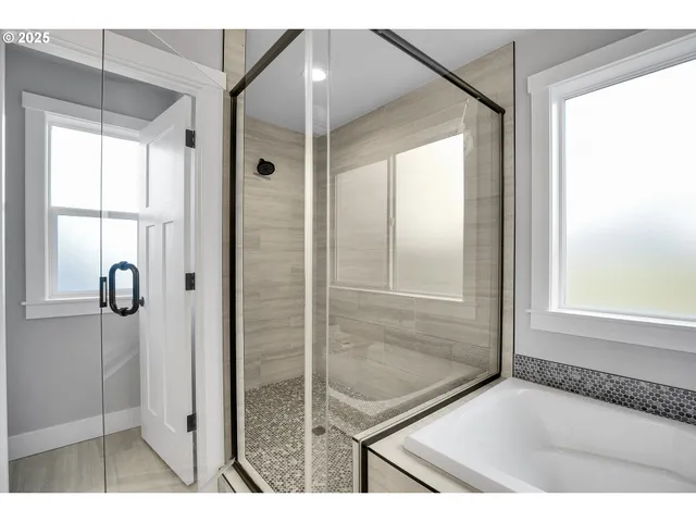 a bathroom with a tub and shower