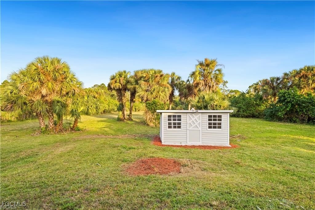 260 13th Street Southwest Naples, FL 34117 - Photo 13 of 13 a view of a big yard with an outdoor space