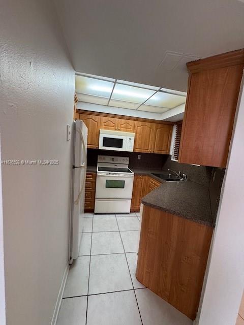 8335 Southwest 152nd Avenue, Unit PH2 Miami, FL 33193 - Photo 12 of 19 a kitchen with granite countertop a refrigerator and a stove top oven