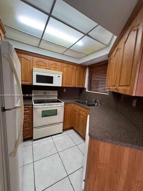 8335 Southwest 152nd Avenue, Unit PH2 Miami, FL 33193 - Photo 13 of 19 a kitchen with stainless steel appliances kitchen island granite countertop a stove a sink and a microwave