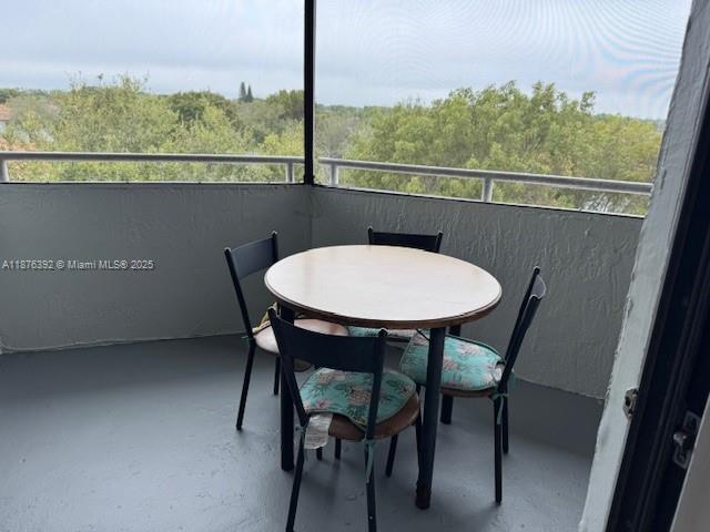 8335 Southwest 152nd Avenue, Unit PH2 Miami, FL 33193 - Photo 15 of 19 a view of a dining room with furniture window and wooden floor