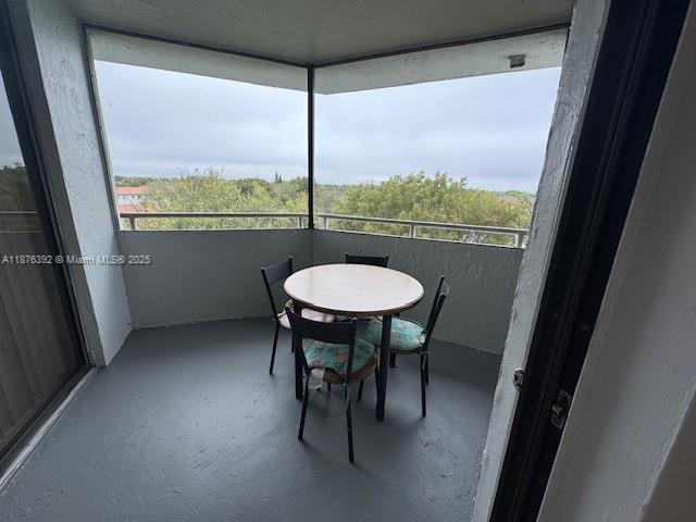 8335 Southwest 152nd Avenue, Unit PH2 Miami, FL 33193 - Photo 16 of 19 a view of a room with a table and chairs