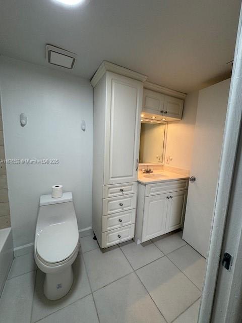 8335 Southwest 152nd Avenue, Unit PH2 Miami, FL 33193 - Photo 3 of 19 a bathroom with a toilet sink and mirror
