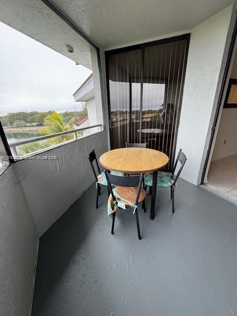 8335 Southwest 152nd Avenue, Unit PH2 Miami, FL 33193 - Photo 7 of 19 a balcony with table and chairs