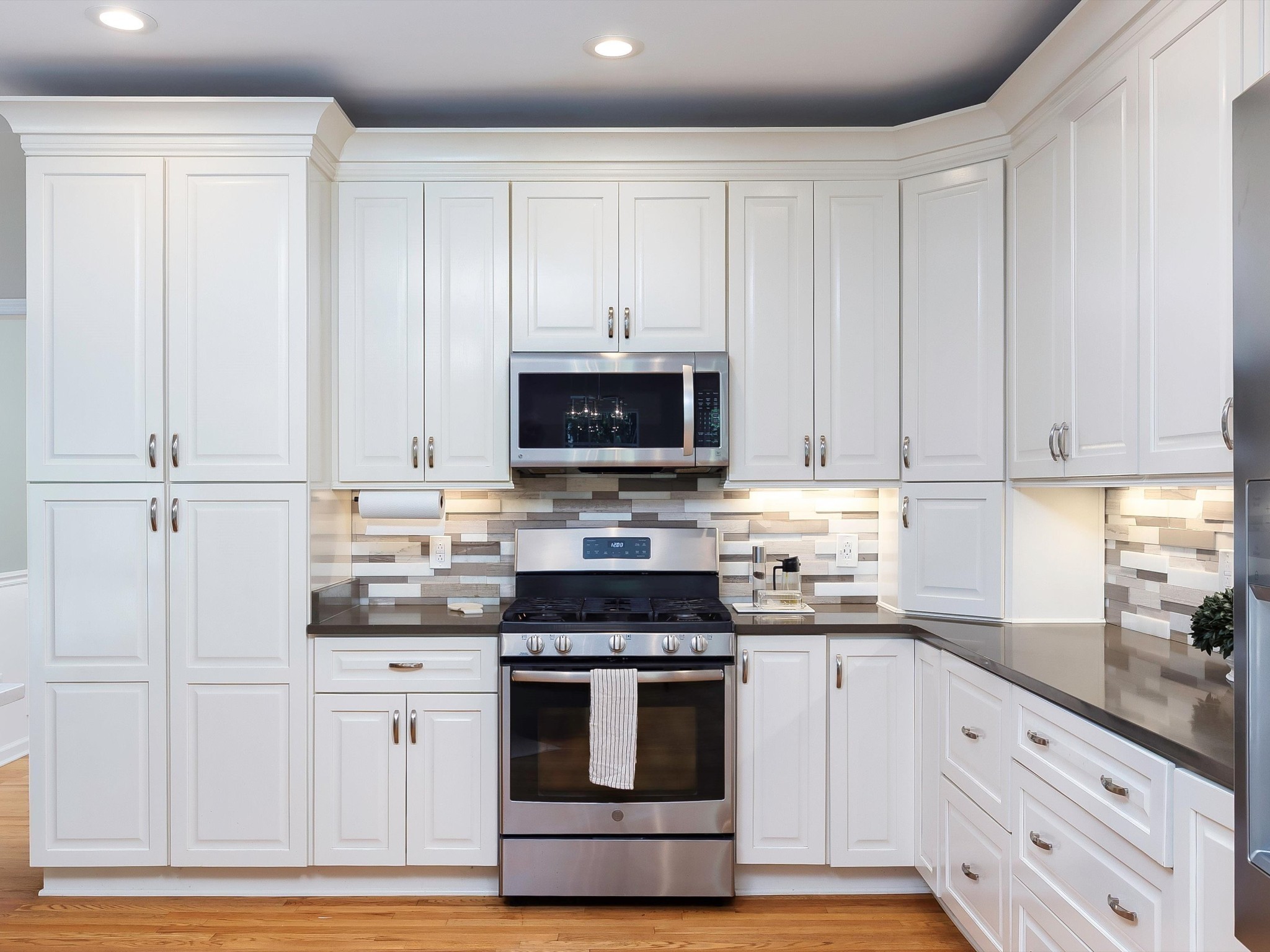 6480 Peytonsville-Arno Road College Grove, TN 37046 - Photo 23 of 96 a kitchen with granite countertop white cabinets and stainless steel appliances