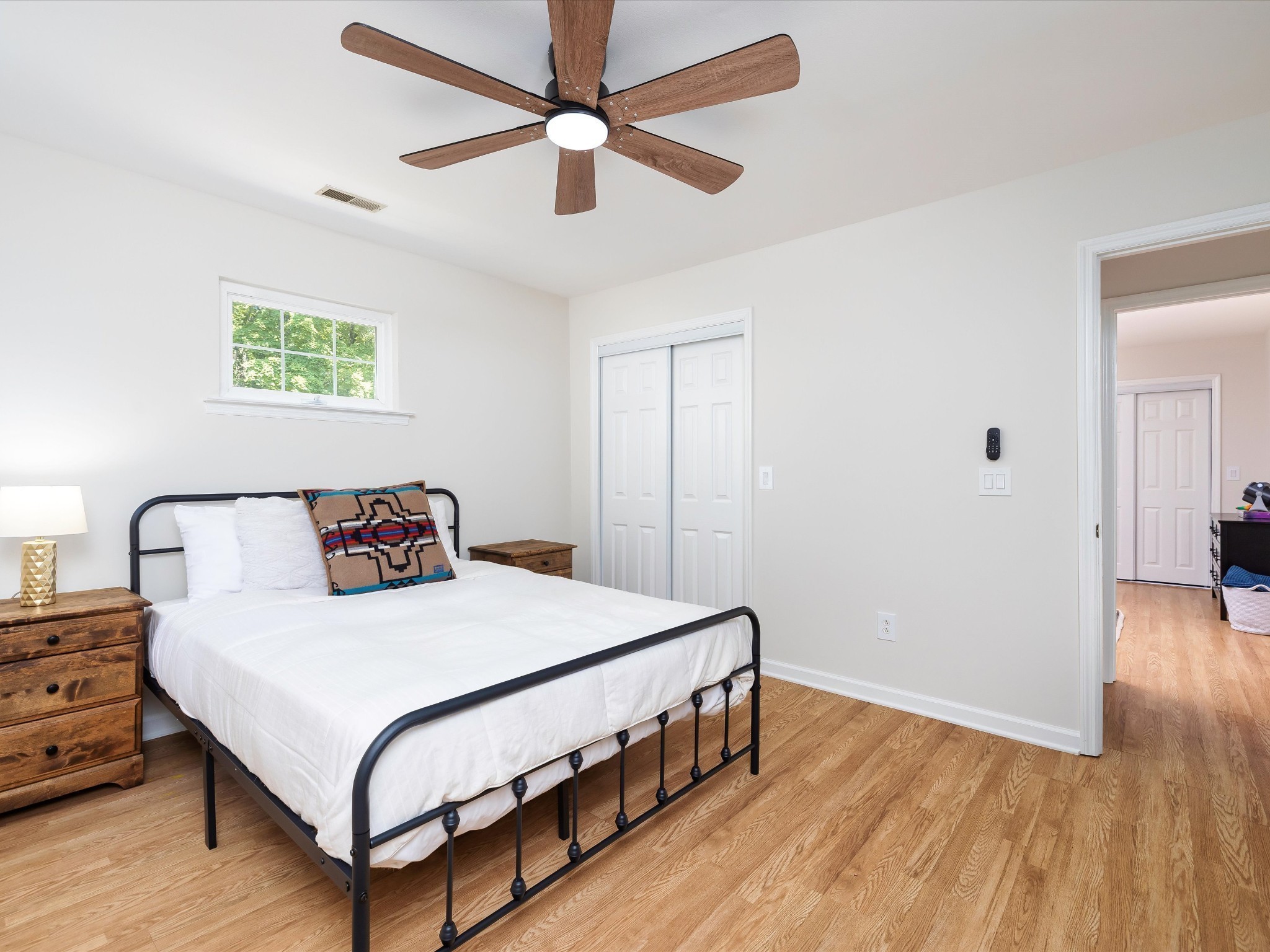6480 Peytonsville-Arno Road College Grove, TN 37046 - Photo 51 of 96 a bedroom with a bed a dresser and wooden floor