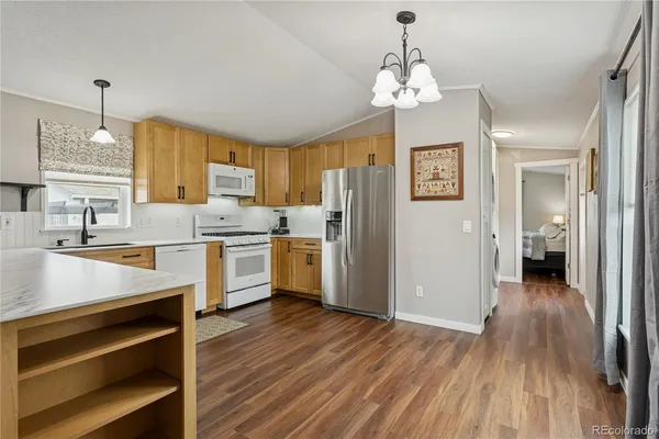 a kitchen with a refrigerator and a sink