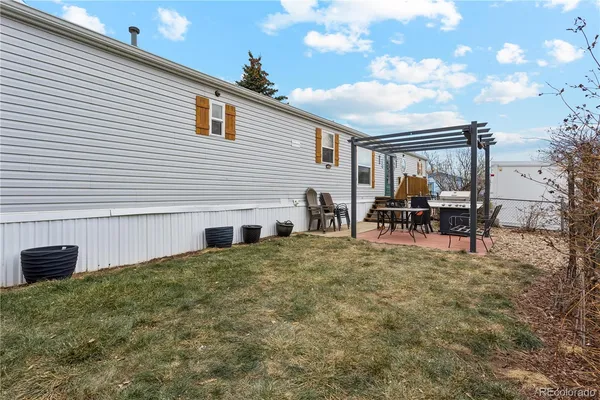 a backyard of a house with table and chairs
