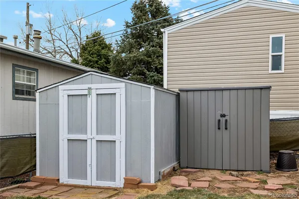 a view of a house with a wooden fence