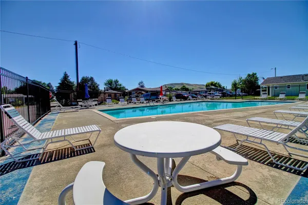 a view of a swimming pool with outdoor seating space