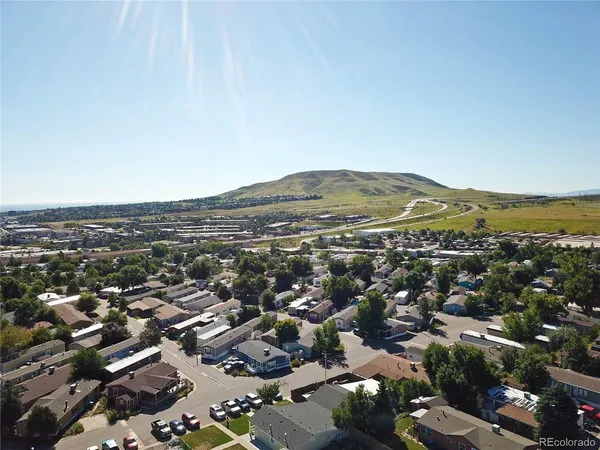 an aerial view of residential houses with city view