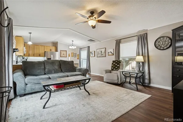 a living room with furniture a clock and a chandelier