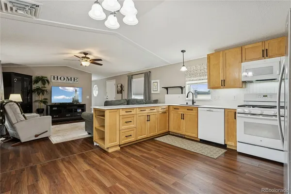 a kitchen with a refrigerator cabinets and wooden floor