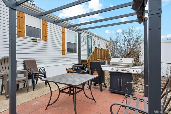 a view of a patio with a table and chairs