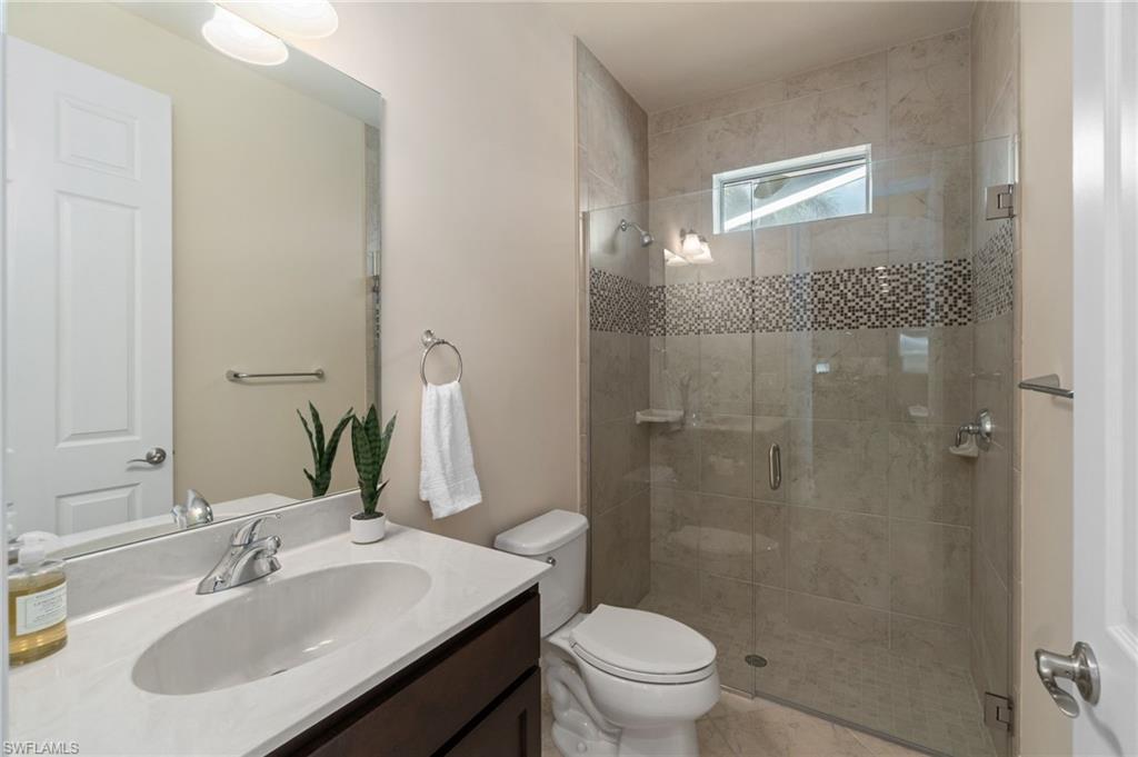 19753 Tesoro Way Estero, FL 33967 - Photo 23 of 47 a bathroom with a sink toilet and shower