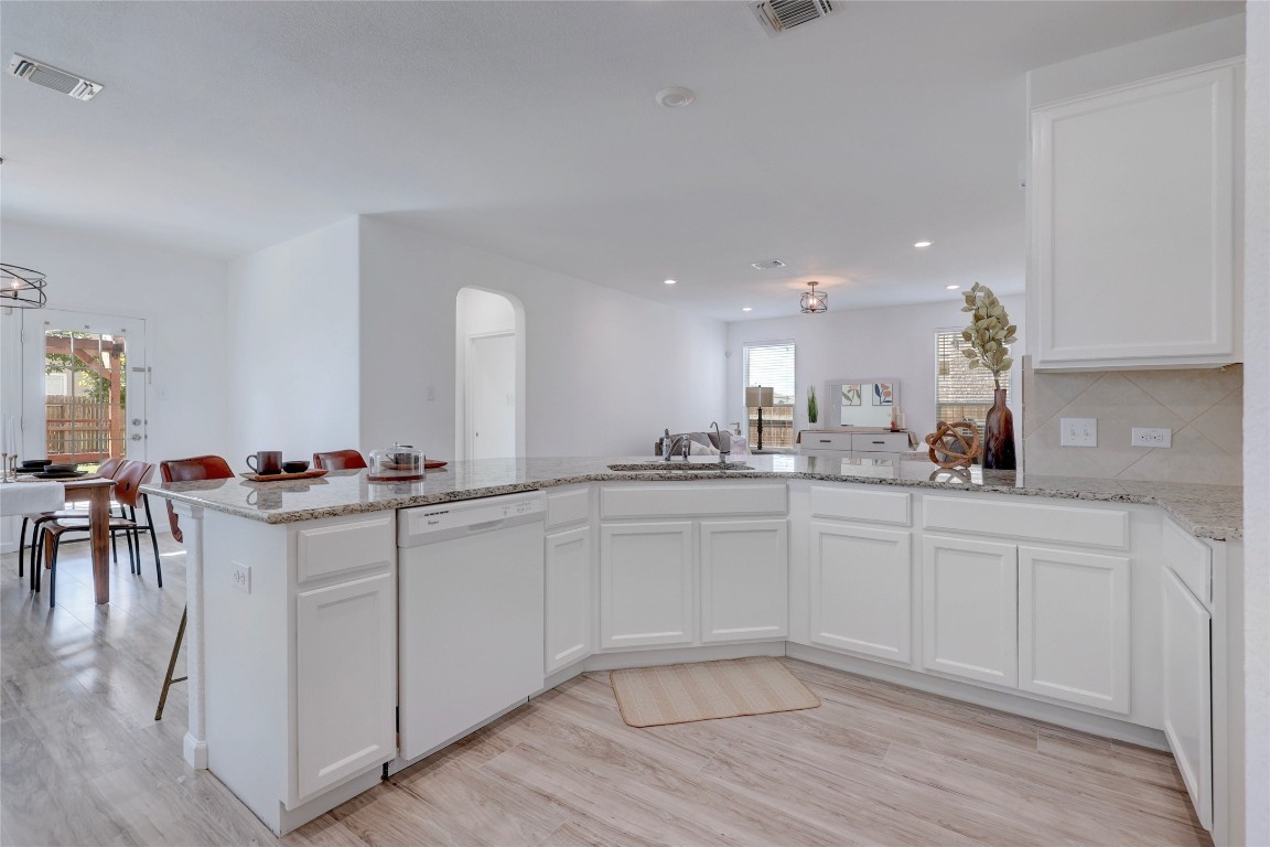 468 Sheepshank Drive Georgetown, TX 78633 - Photo 12 of 27 a kitchen with white cabinets and sink