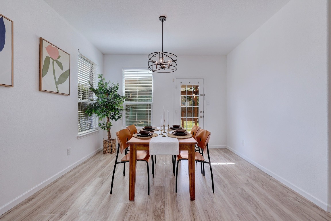 468 Sheepshank Drive Georgetown, TX 78633 - Photo 13 of 27 a view of a dining room with furniture window and wooden floor