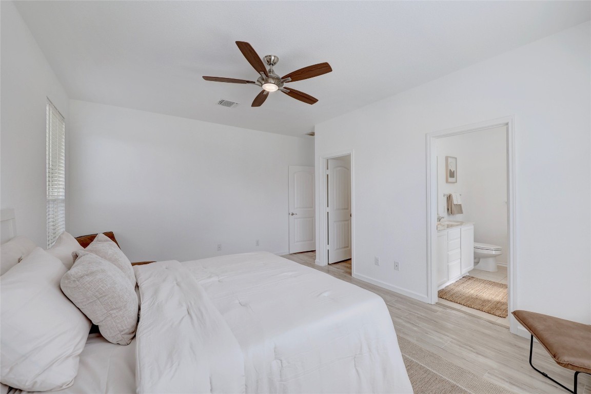 468 Sheepshank Drive Georgetown, TX 78633 - Photo 16 of 27 a bedroom with a large bed and wooden floor