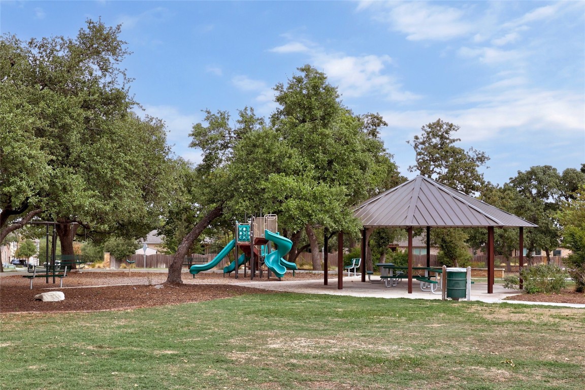 468 Sheepshank Drive Georgetown, TX 78633 - Photo 27 of 27 a view of a swimming pool with lawn chairs under an umbrella