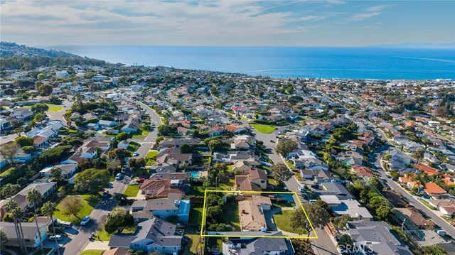 a view of a lush green field with mountains in the background