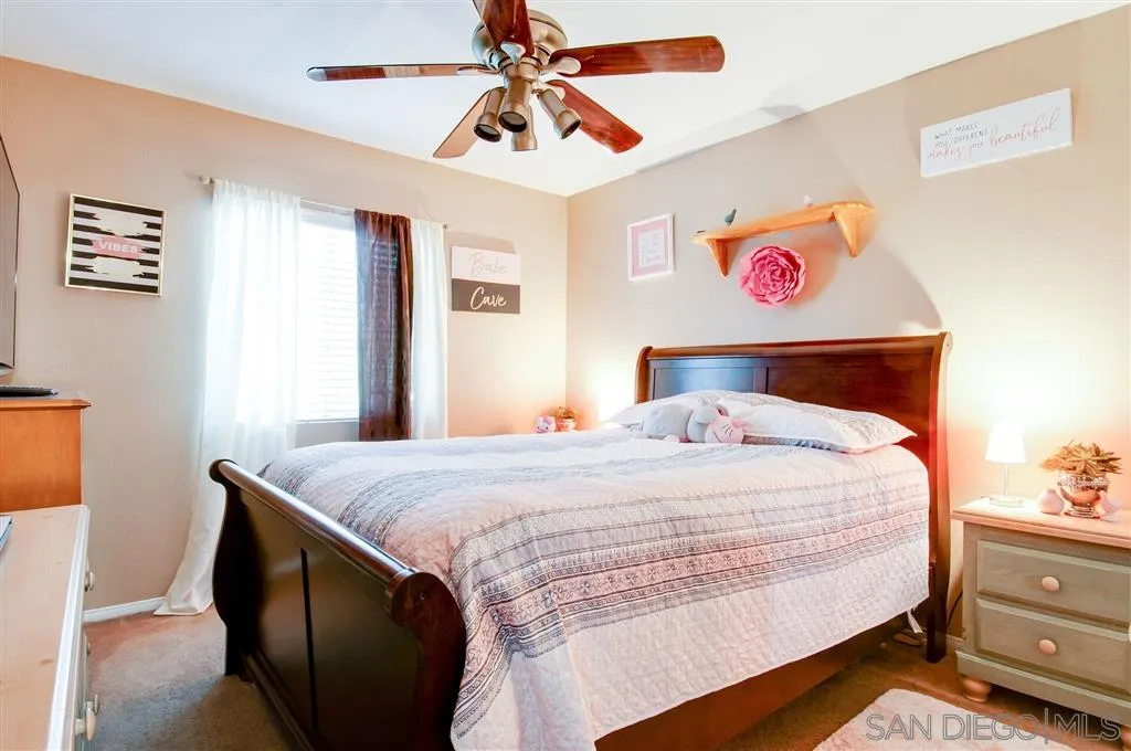 38305 Encanto Road Murrieta, CA 92563 - Photo 12 of 24 a bedroom with a bed and a chandelier