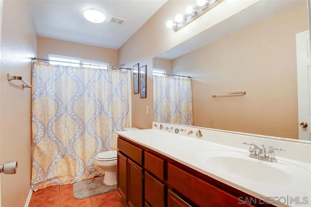 38305 Encanto Road Murrieta, CA 92563 - Photo 15 of 24 a bathroom with a double vanity sink mirror and toilet