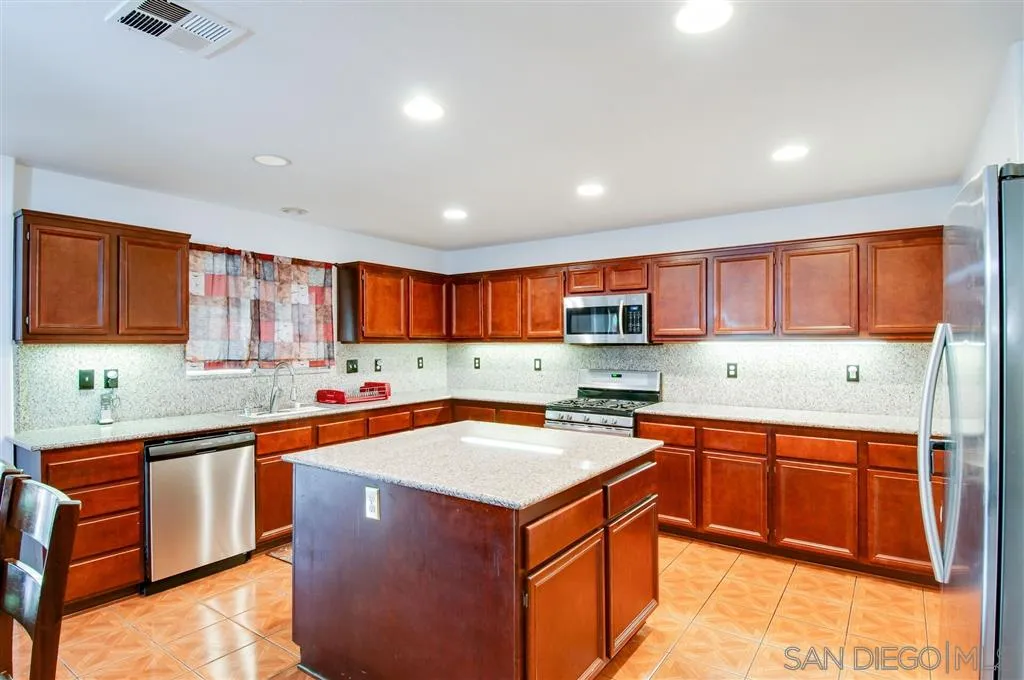 38305 Encanto Road Murrieta, CA 92563 - Photo 17 of 24 a kitchen with a sink stove top oven and cabinets