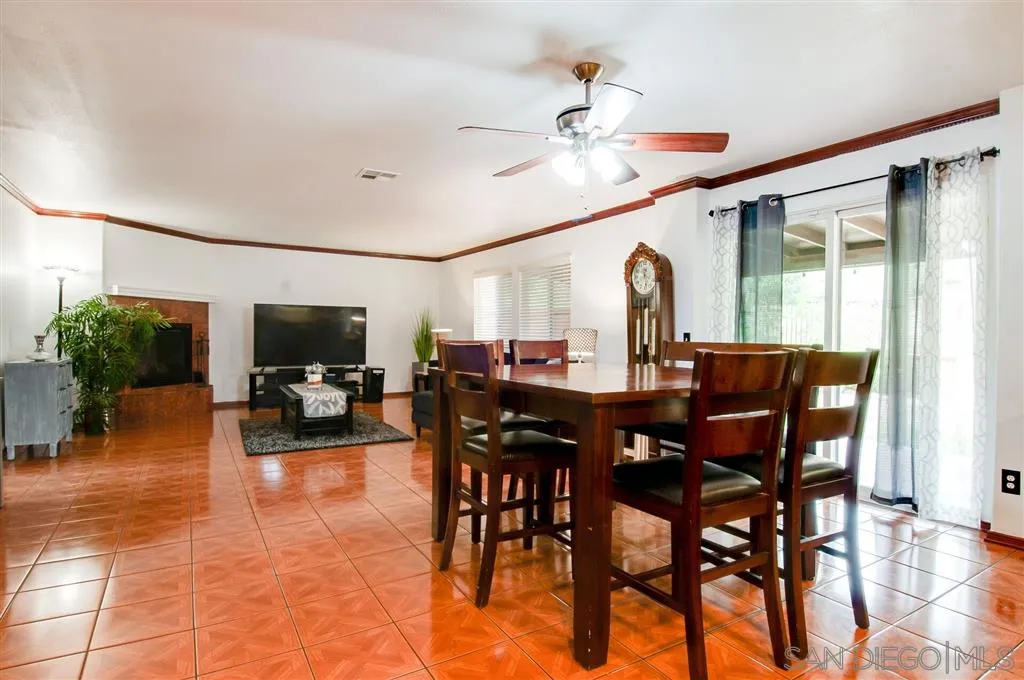 38305 Encanto Road Murrieta, CA 92563 - Photo 23 of 24 a view of a dining room and livingroom with furniture a chandelier and wooden floor