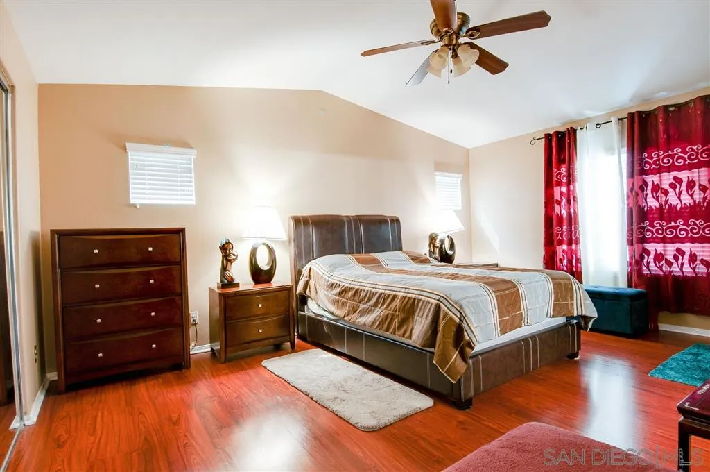 38305 Encanto Road Murrieta, CA 92563 - Photo 5 of 24 a bedroom with a bed and a chandelier
