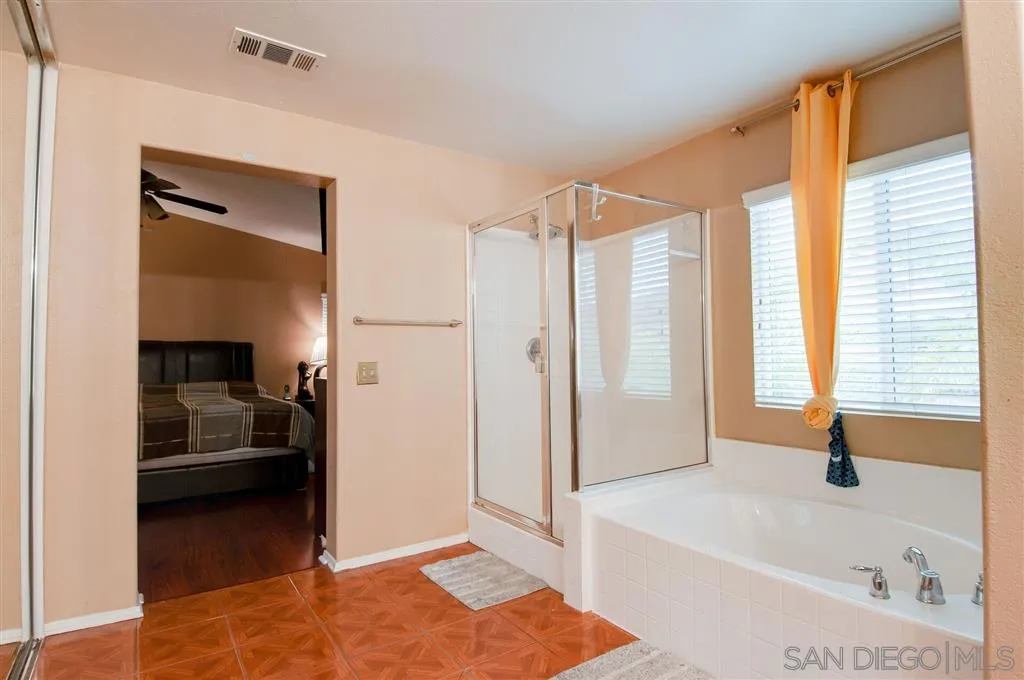 38305 Encanto Road Murrieta, CA 92563 - Photo 7 of 24 a bathroom with a tub sink and shower
