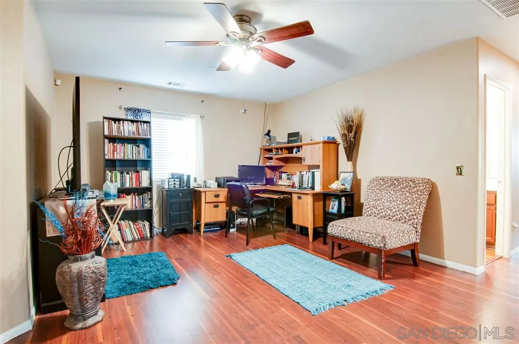 38305 Encanto Road Murrieta, CA 92563 - Photo 8 of 24 a living room with furniture and a book shelf