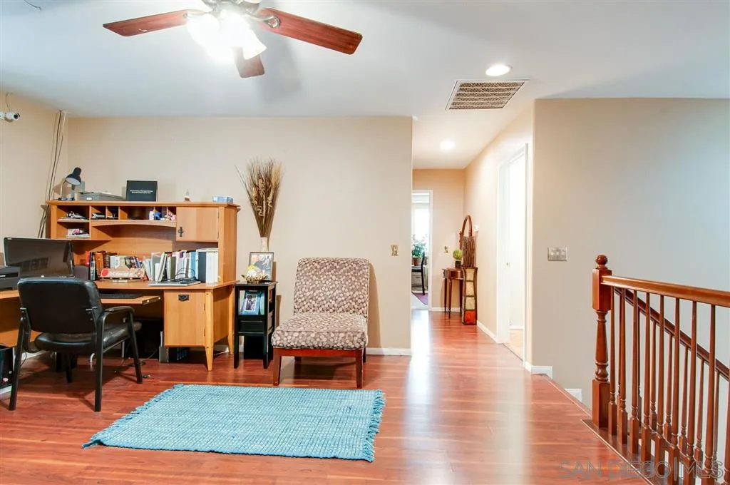 38305 Encanto Road Murrieta, CA 92563 - Photo 9 of 24 a living room with furniture and a wooden floor