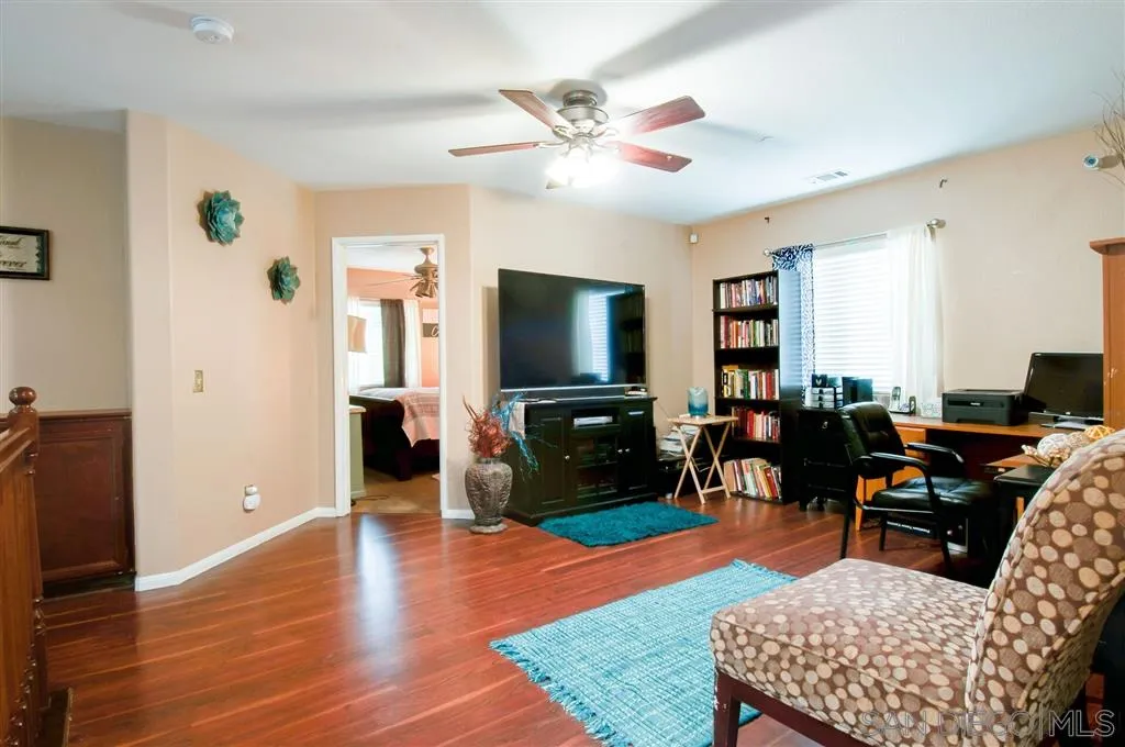 38305 Encanto Road Murrieta, CA 92563 - Photo 10 of 24 a living room with furniture and a flat screen tv
