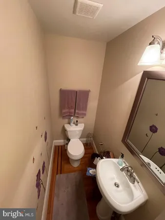 a bathroom with a sink toilet and mirror