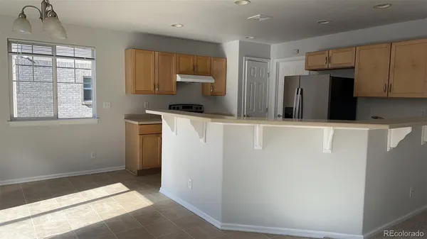 a kitchen with stainless steel appliances a refrigerator and a stove top oven
