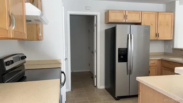 a kitchen with stainless steel appliances a refrigerator and a stove