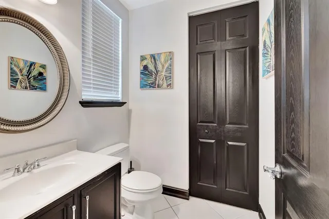 a bathroom with a toilet a sink and a mirror